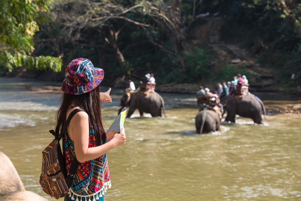 Female tourists on hand have a happy travel map.